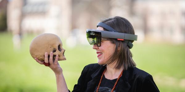 Elizabeth Hunter strikes a Hamlet pose with a prop skull. 