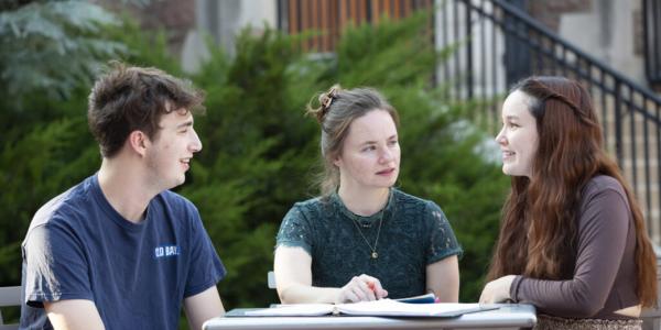 Playwright and screenwriter Liza Birkenmeier, a 2008 alumna (center), works with seniors Zachary Stern and Melia Van Hecke as part of the 2022 A.E. Hotchner Playwriting Festival. (Photo: Jerry Naunheim Jr./Washington University)