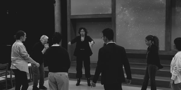 an instructor and seven cast members in a circle