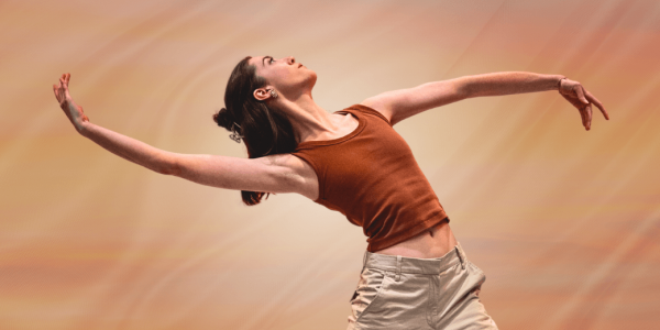 A Dancer has her arms spread wide