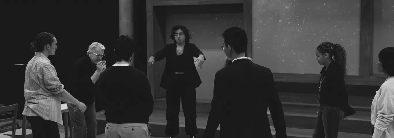 an instructor and seven cast members in a circle